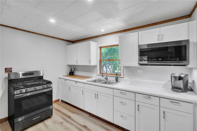 466 Whetstone Rd, Mountain Rest, SC 29664 - kitchen featuring stainless steel appliances, a sink, white cabinetry, light countertops, and light wood-style flooring