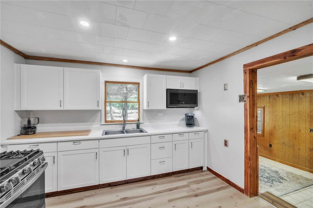 466 Whetstone Rd, Mountain Rest, SC 29664 - kitchen featuring a sink, white cabinetry, light countertops, ornamental molding, and light wood-type flooring