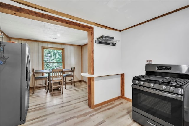 466 Whetstone Rd, Mountain Rest, SC 29664 - kitchen with stainless steel appliances, baseboards, light wood-style floors, ornamental molding, and wood walls