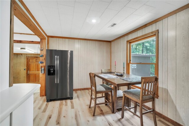 466 Whetstone Rd, Mountain Rest, SC 29664 - dining room featuring light wood-type flooring, wood walls, and baseboards