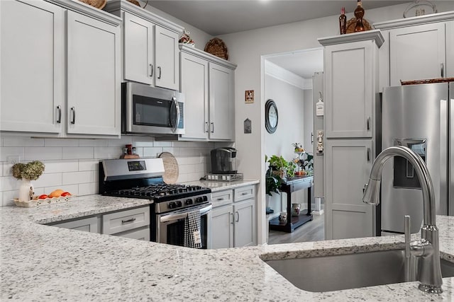 133 Shipyard Cir, Anderson, SC 29621 - kitchen with appliances with stainless steel finishes, a sink, tasteful backsplash, light stone countertops, and ornamental molding