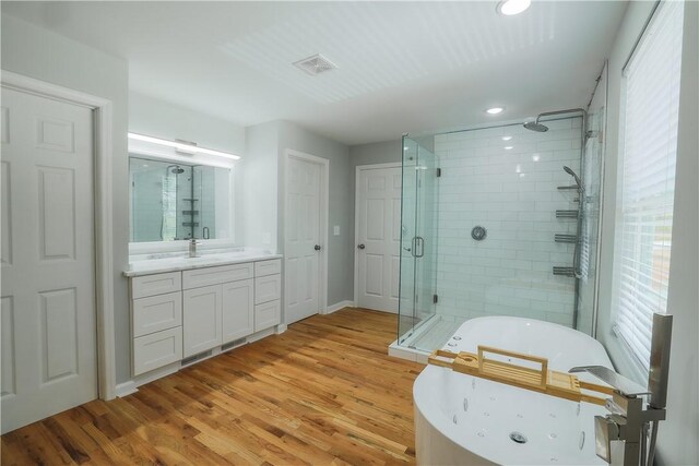 425 Lakewood Dr, Townville, SC 29689 - full bath featuring a shower stall, a whirlpool tub, wood finished floors, vanity, and recessed lighting