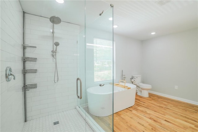 425 Lakewood Dr, Townville, SC 29689 - full bathroom featuring a stall shower, a soaking tub, toilet, recessed lighting, and wood finished floors