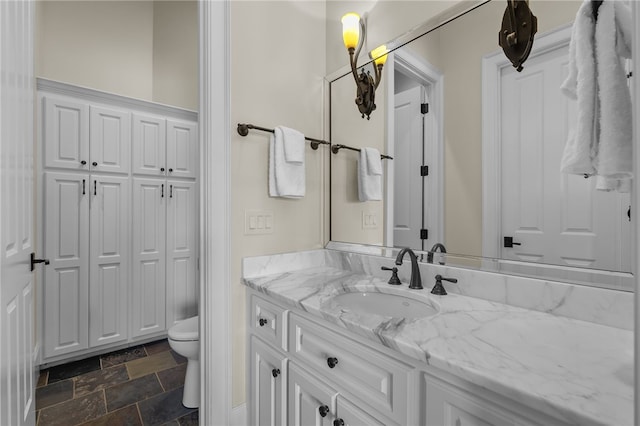 117 Misty Water Loop, Sunset, SC 29685 - bathroom featuring vanity, toilet, and stone finish flooring