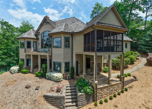 117 Misty Water Loop, Sunset, SC 29685 - view of front facade featuring stucco siding, a balcony, stone siding, and a sunroom