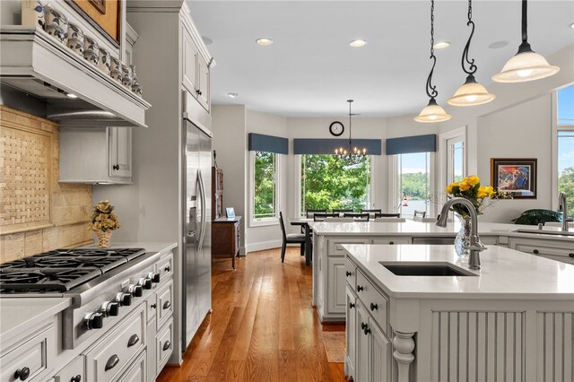 117 Misty Water Loop, Sunset, SC 29685 - kitchen with stainless steel appliances, premium range hood, an island with sink, light countertops, and recessed lighting