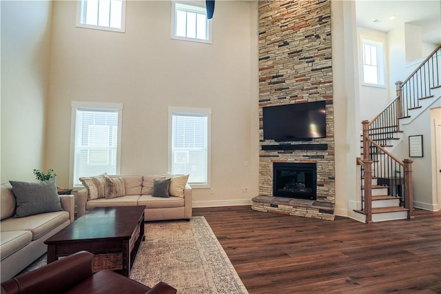 117 Founders Blvd, Central, SC 29630 - living area with a towering ceiling, stairs, dark wood-style floors, a fireplace, and baseboards