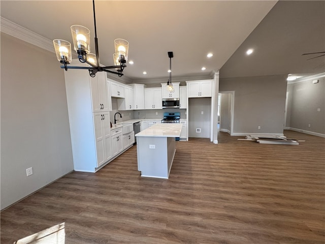 629 Mountain View Rd, Williamston, SC 29697 - kitchen with appliances with stainless steel finishes, ornamental molding, a kitchen island, white cabinets, and recessed lighting