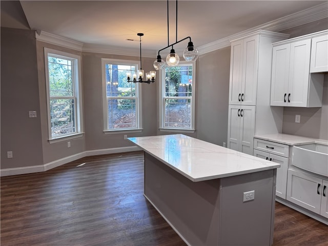 629 Mountain View Rd, Williamston, SC 29697 - kitchen with white cabinets, crown molding, light stone countertops, a kitchen island, and a chandelier