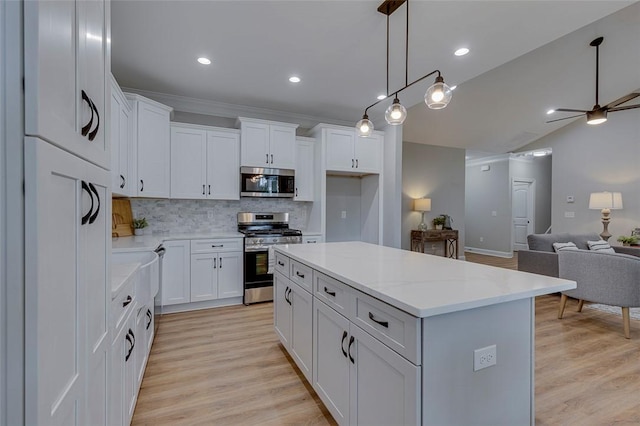 629 Mountain View Rd, Williamston, SC 29697 - kitchen featuring stainless steel appliances, open floor plan, backsplash, a kitchen island, and white cabinetry