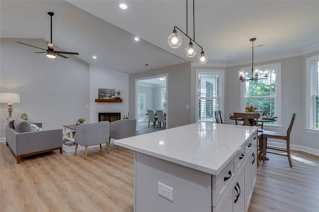 629 Mountain View Rd, Williamston, SC 29697 - kitchen with open floor plan, light wood-style floors, a large fireplace, recessed lighting, and ornamental molding