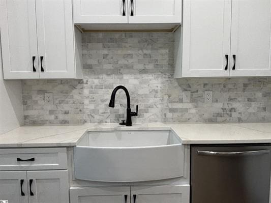 629 Mountain View Rd, Williamston, SC 29697 - kitchen with stainless steel dishwasher, white cabinetry, decorative backsplash, and light stone counters