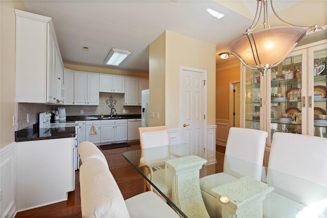 704 Nottingham Ct, Seneca, SC 29672 - dining room featuring dark wood finished floors, wainscoting, and a decorative wall