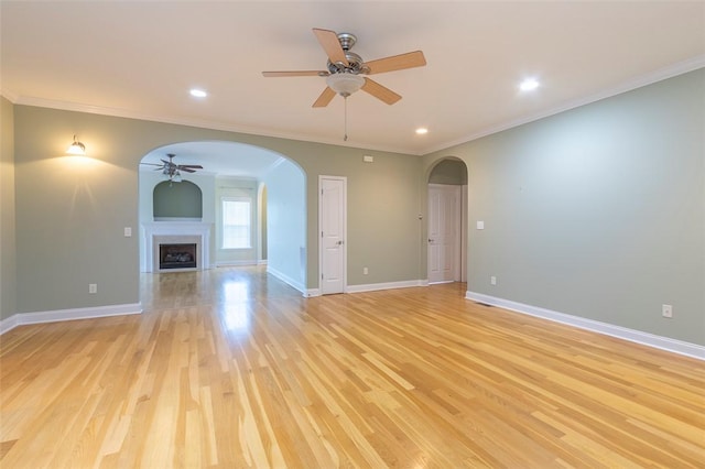 207 W Green Chase, Anderson, SC 29621 - unfurnished living room with a ceiling fan, arched walkways, light wood finished floors, ornamental molding, and baseboards