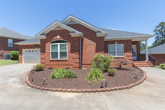 207 W Green Chase, Anderson, SC 29621 - view of front facade featuring central air condition unit, driveway, brick siding, an attached garage, and roof with shingles