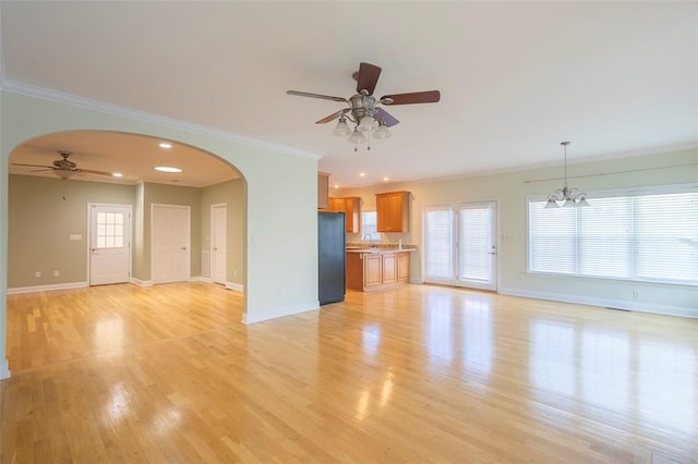 207 W Green Chase, Anderson, SC 29621 - unfurnished living room with ceiling fan, arched walkways, baseboards, light wood-style floors, and ornamental molding