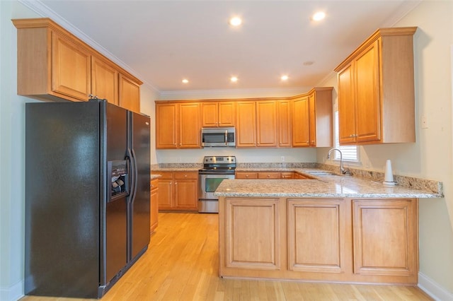 207 W Green Chase, Anderson, SC 29621 - kitchen with stainless steel appliances, a sink, a peninsula, light wood-type flooring, and light stone counters