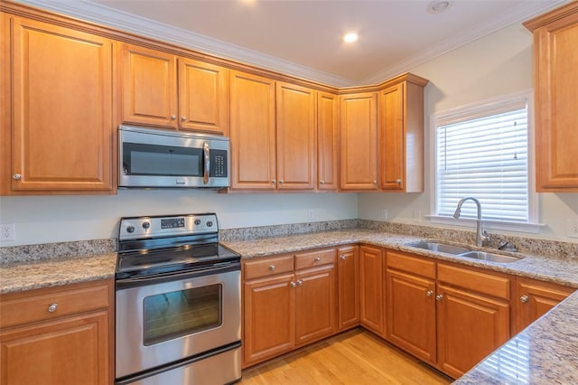 207 W Green Chase, Anderson, SC 29621 - kitchen with appliances with stainless steel finishes, a sink, light wood-style floors, ornamental molding, and brown cabinets