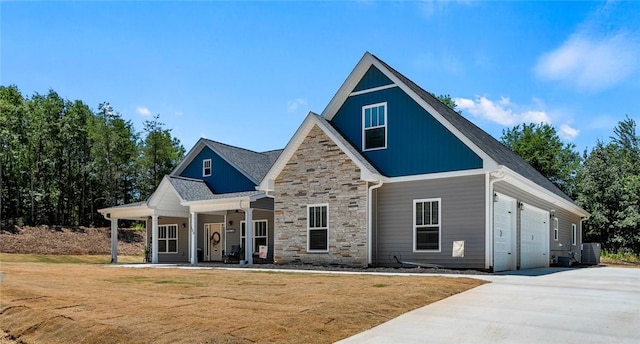 100 Grandview Dr, Anderson, SC 29625 - craftsman-style house featuring stone siding, covered porch, concrete driveway, an attached garage, and a front yard