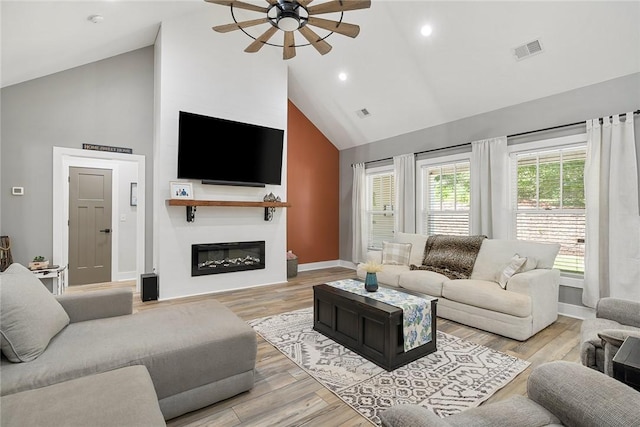 100 Grandview Dr, Anderson, SC 29625 - living room featuring high vaulted ceiling, a ceiling fan, baseboards, a glass covered fireplace, and light wood-style flooring