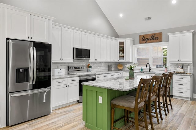 100 Grandview Dr, Anderson, SC 29625 - kitchen featuring stainless steel appliances, white cabinetry, backsplash, a breakfast bar area, and recessed lighting