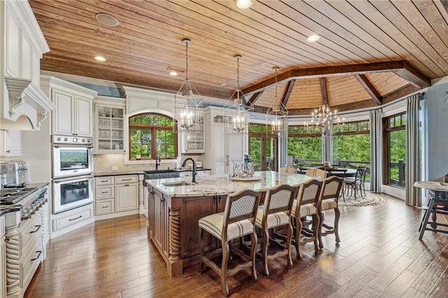 194 Cool Water Way, Sunset, SC 29685 - kitchen with wooden ceiling, a chandelier, a sink, a center island with sink, and a kitchen bar