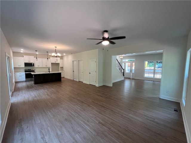116 Fern Cir, Clemson, SC 29631 - unfurnished living room with dark wood finished floors, baseboards, a chandelier, stairway, and a ceiling fan