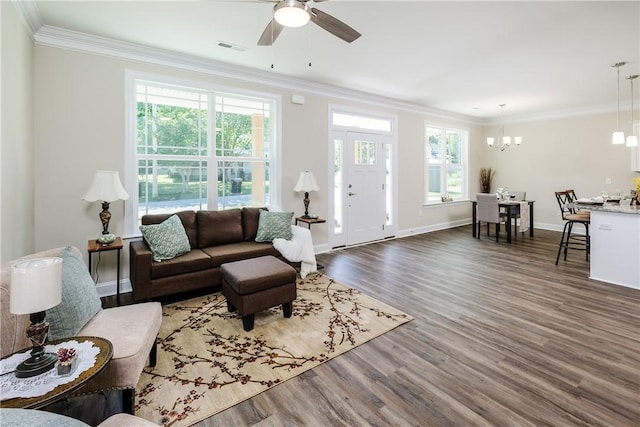 106 N St, Belton, SC 29627 - living area featuring healthy amount of natural light, dark wood-type flooring, crown molding, ceiling fan, and a chandelier