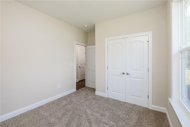 106 N St, Belton, SC 29627 - unfurnished bedroom featuring carpet floors, a closet, and baseboards