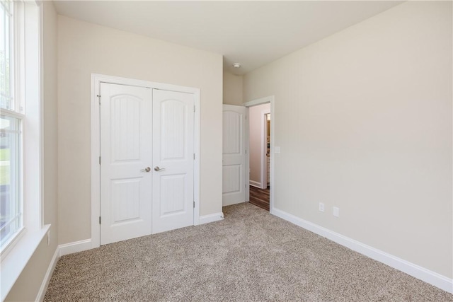106 N St, Belton, SC 29627 - unfurnished bedroom with carpet flooring, a closet, and baseboards