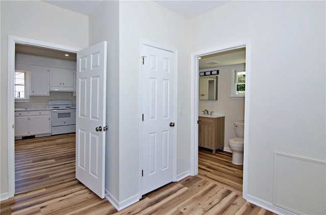 208 Aiken St, Central, SC 29630 - hall featuring light wood finished floors, healthy amount of natural light, a sink, and baseboards