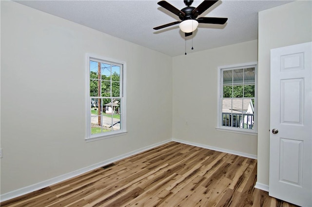 208 Aiken St, Central, SC 29630 - empty room with wood finished floors, plenty of natural light, baseboards, and a ceiling fan