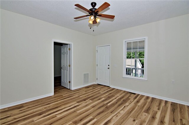 208 Aiken St, Central, SC 29630 - spare room featuring light wood-type flooring, baseboards, a ceiling fan, and a textured ceiling