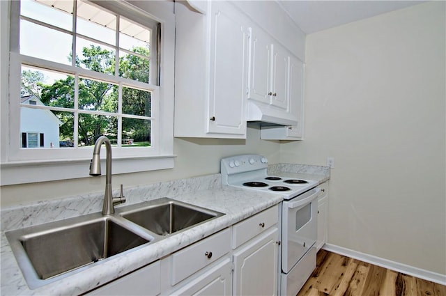 208 Aiken St, Central, SC 29630 - kitchen featuring white electric stove, under cabinet range hood, a sink, light wood-style flooring, and white cabinetry