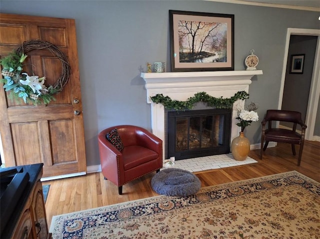 709 Ferry St, Anderson, SC 29626 - living area with wood finished floors, a fireplace with flush hearth, baseboards, and crown molding