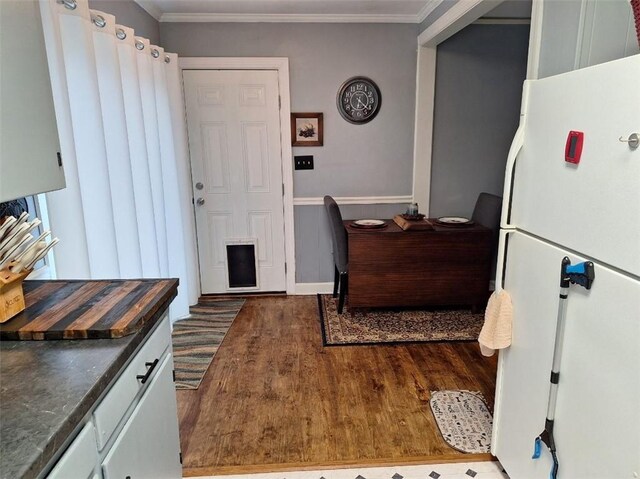 709 Ferry St, Anderson, SC 29626 - kitchen featuring freestanding refrigerator, dark wood-style flooring, dark countertops, baseboards, and crown molding