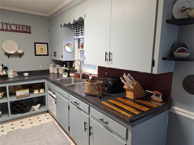 709 Ferry St, Anderson, SC 29626 - kitchen with open shelves, a sink, dark countertops, ornamental molding, and white cabinetry