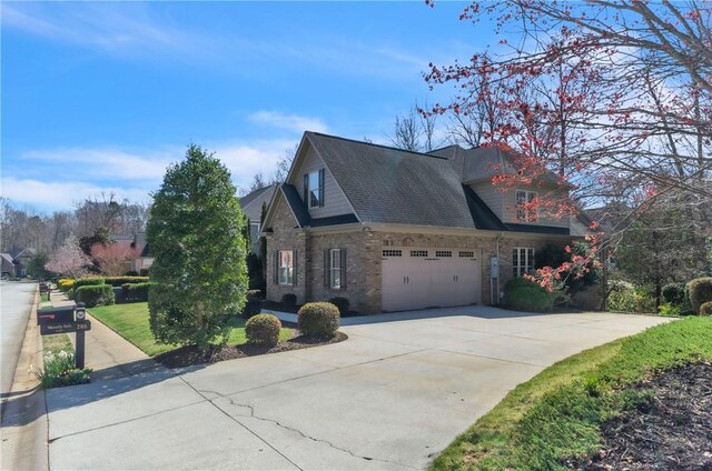 206 Waverly Hall Ln, Simpsonville, SC 29681 - view of side of home featuring concrete driveway, a garage, brick siding, and a shingled roof