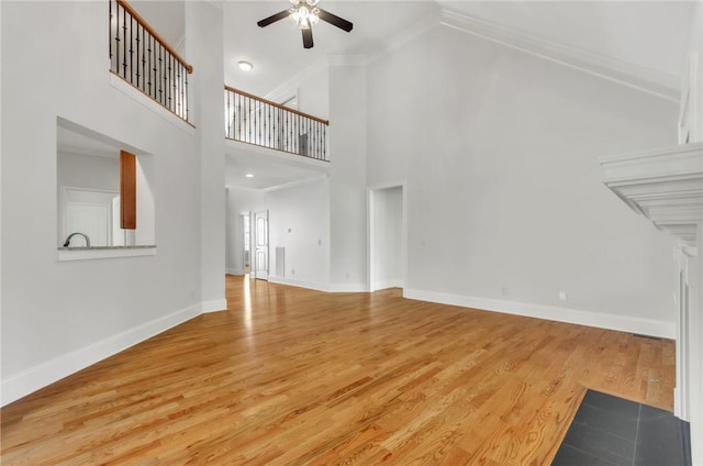 206 Waverly Hall Ln, Simpsonville, SC 29681 - unfurnished living room with ceiling fan, ornamental molding, wood finished floors, baseboards, and high vaulted ceiling