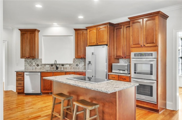 206 Waverly Hall Ln, Simpsonville, SC 29681 - kitchen with appliances with stainless steel finishes, a sink, crown molding, light wood-type flooring, and tasteful backsplash