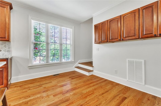 206 Waverly Hall Ln, Simpsonville, SC 29681 - spare room with light wood-style floors, baseboards, ornamental molding, and stairs