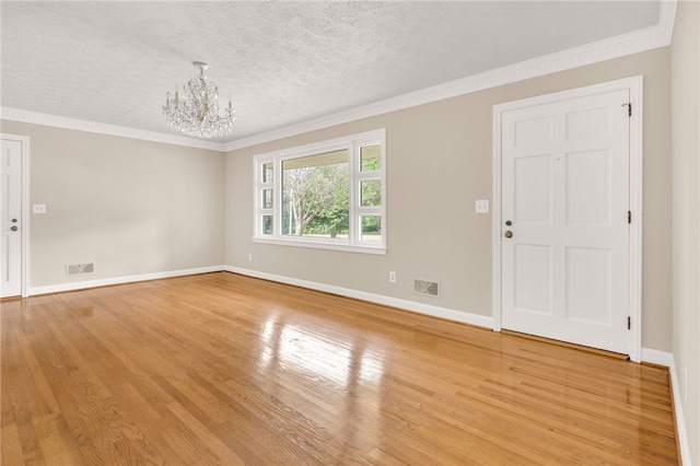 1142 Fox Squirrel Ridge Rd, Pickens, SC 29671 - empty room with a chandelier, light wood-style floors, baseboards, ornamental molding, and a textured ceiling