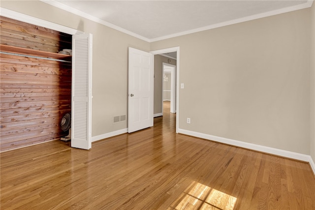 1142 Fox Squirrel Ridge Rd, Pickens, SC 29671 - unfurnished bedroom featuring baseboards, crown molding, light wood-style floors, and a closet