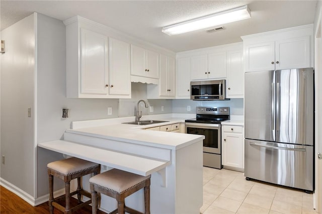 104 Brittania Cir, Anderson, SC 29621 - kitchen with appliances with stainless steel finishes, a sink, a peninsula, light countertops, and white cabinets