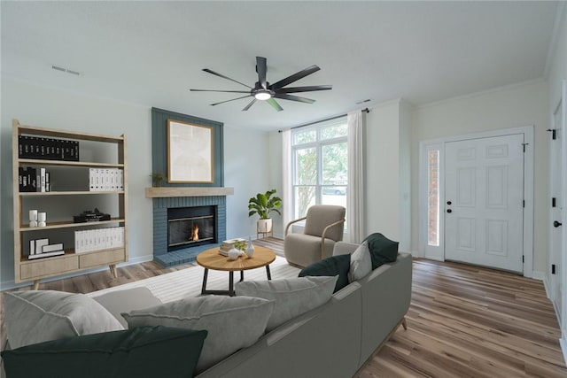 2413 Annandale Dr, Anderson, SC 29621 - living area with ceiling fan, wood finished floors, a brick fireplace, crown molding, and baseboards