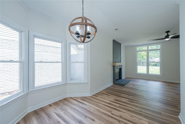 2413 Annandale Dr, Anderson, SC 29621 - unfurnished living room with a chandelier, wood finished floors, baseboards, and a glass covered fireplace