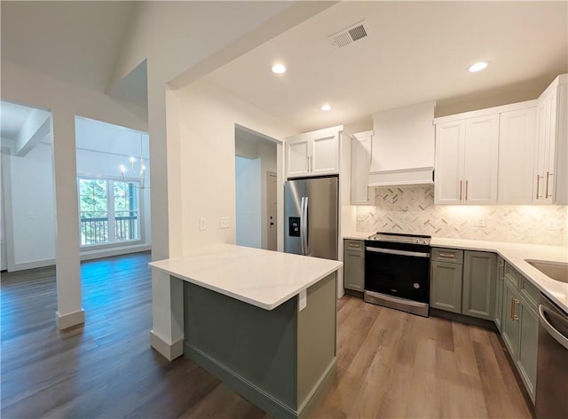 36 Pine Garden Way Dr, Salem, SC 29676 - kitchen with appliances with stainless steel finishes, tasteful backsplash, light wood-style flooring, a peninsula, and light countertops