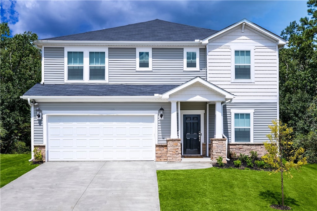 605 Tilson Rd, Simpsonville, SC 29680 - view of front facade featuring a front yard, concrete driveway, stone siding, and a garage