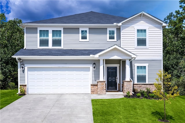 605 Tilson Rd, Simpsonville, SC 29680 - view of front facade featuring a front yard, concrete driveway, stone siding, and a garage