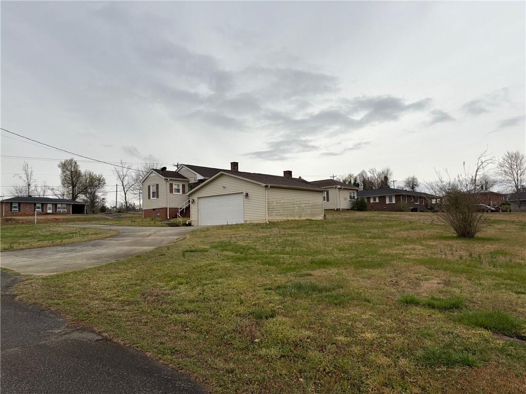 611 E S 6th St, Seneca, SC 29678 - view of home's exterior featuring driveway, a yard, and an attached garage
